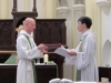 Dean Andrew presenting the constitution and canons