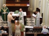 Treasurer presenting a Bible to Fr. Nigel