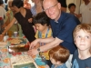 Fr. Nigel serving cake
